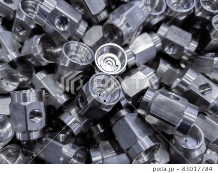 pile of abstract industrial close-up full frame background of shiny steel turned hexagonal parts 83017784