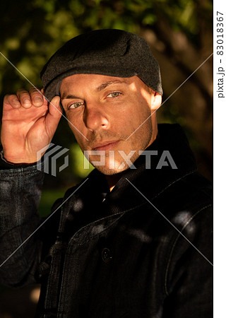 Adult handsome man in a coat and cap. 83018367