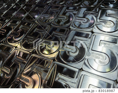 shiny metal machined digit 5 plates tiled tightly - full frame background 83018987