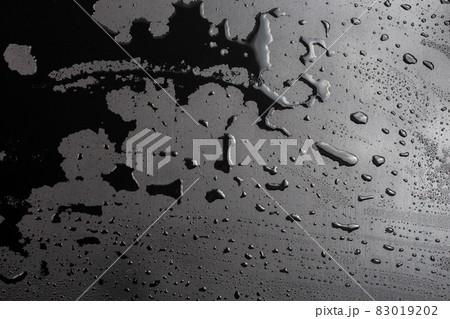 abstract background of wet black hydrophobic surface - close-up with selective focus 83019202