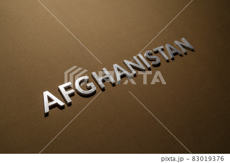 the word afghanistan laid with silver metal letters on rough tan khaki canvas fabric the word afghanistan laid with silver metal letters on rough tan khaki canvas fabric 83019376