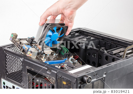 hand putting in or removing pc internals while maintenance personal computer hardware with selective focus hand putting in or removing pc internals while maintenance personal computer hardware with selective focus 83019421