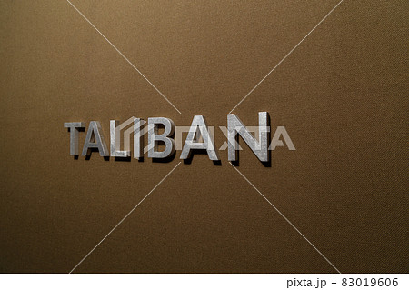the word taliban laid with silver metal letters on rough tan khaki canvas fabric the word taliban laid with silver metal letters on rough tan khaki canvas fabric 83019606