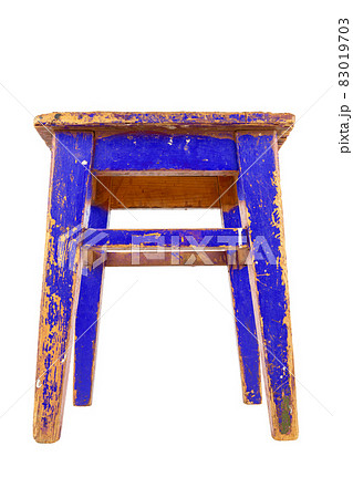 Old blue wooden stool with peeling paint. Loft style chair isolated on a white background. 83019703