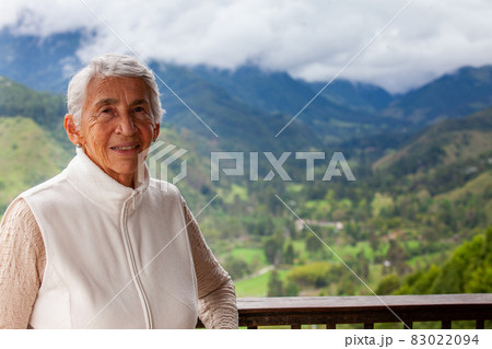 Senior woman at the beautiful view point over the Cocora Valley in Salento, located on the region of Quindio in Colombia 83022094