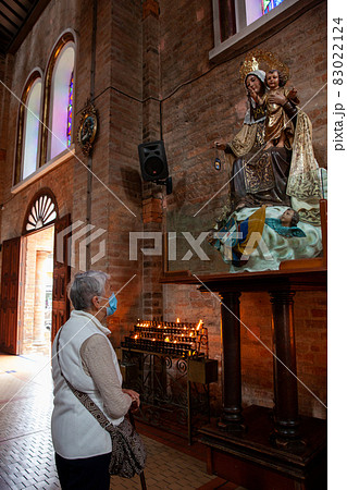 Senior woman praying at the historical Cathedral of Our Lady of Poverty of Pereira, built in 1890 Senior woman praying at the historical Cathedral of Our Lady of Poverty of Pereira, built in 1890 83022124