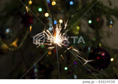 Burning Sparkler fire amid Christmas tree lights Burning Sparkler fire amid Christmas tree lights 83024556