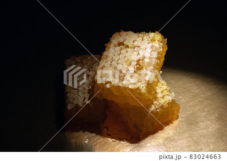 sweet organic honey on dark background 83024663