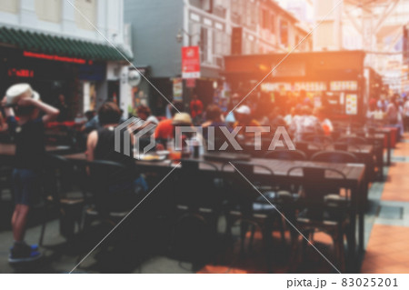 Blurred background of people and street food market with warm flare lights. Blurred background of people and street food market with warm flare lights. 83025201