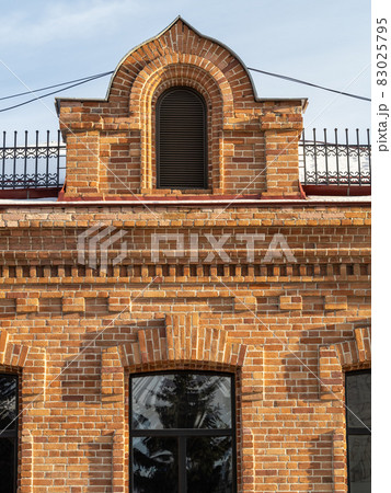 The window of the old mansion 19 century with brown bricks wall The window of the old mansion 19 century with brown bricks wall 83025795
