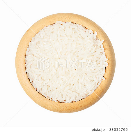 Raw white rice in wooden cup isolated on white background. Raw white rice in wooden cup isolated on white background. 83032766