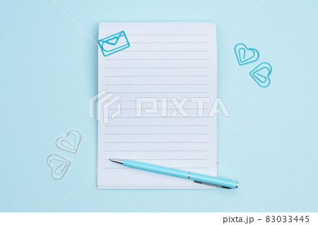 Notebook with stationery items on blue background flat lay. 83033445