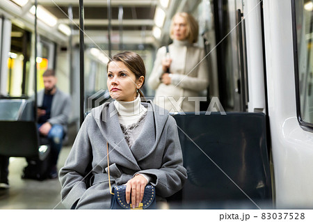 Young thoughtful woman in streetcar Young thoughtful woman in streetcar 83037528