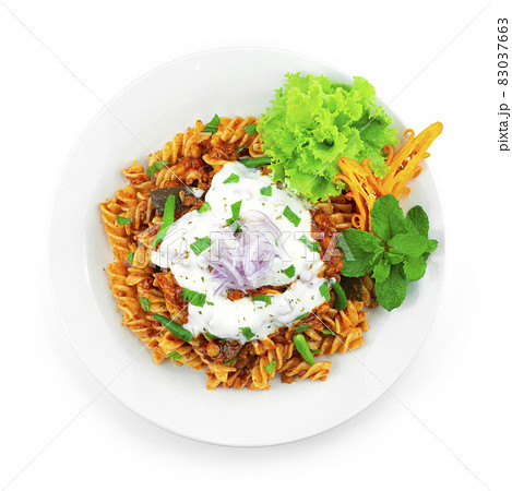 Pasta Bolognese Lentil Curry Sauce ontop Yogurt Sauce and leaf mint Pasta Bolognese Lentil Curry Sauce ontop Yogurt Sauce and leaf mint 83037663