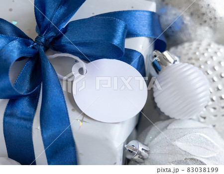 Christmas present with blank gift tag closeup, Mockup Christmas present with blank gift tag closeup, Mockup 83038199