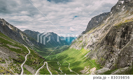 Trollstigen, Andalsnes, Norway. Cars Goes On Serpentine Mountain Road Trollstigen. Famous Norwegian Landmark And Popular Destination. Norwegian County Road 63 In Summer Day. 4K Trollstigen, Andalsnes, Norway. Cars Goes On Serpentine Mountain Road Trollstigen. Famous Norwegian Landmark And Popular Destination. Norwegian County Road 63 In Summer Day. 4K 83039856
