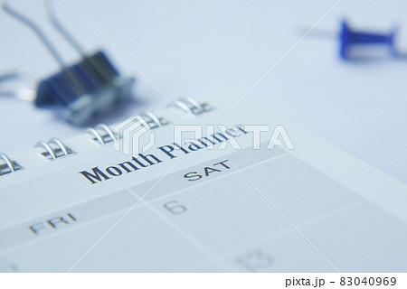 close up of monthly planner and notepad on table  83040969