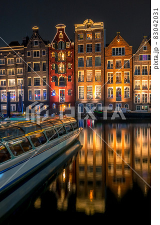 Night Amsterdam Houses on Water and Pleasure Boat Night Amsterdam Houses on Water and Pleasure Boat 83042031