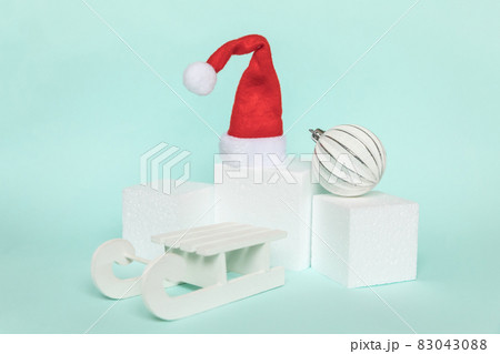 Simply minimal composition winter objects ornament and cube shapes geometric form podium isolated blue pastel background. Christmas New Year december time for celebration concept. Mockup, copy space 83043088