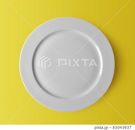 white ceramic plate on yellow 83043637