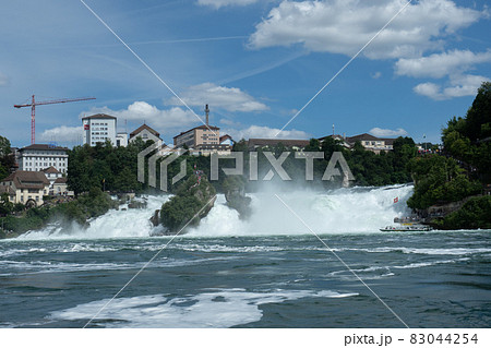 Rhine waterfalls in Southern Germany on a sunny afternoon at high water level 83044254