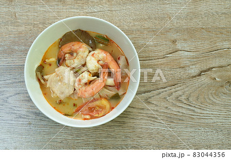 boiled river shrimp and bass fish with mushroom in Thai spicy soup or tom yum kung on bowl 83044356