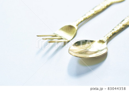 golden spoon and fork for on white background 83044358