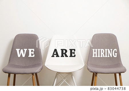 Head hunting help wanted poster concept. Minimalistic composition with chair and blank copy space wall. Head hunting help wanted poster concept. Minimalistic composition with chair and blank copy space wall. 83044738