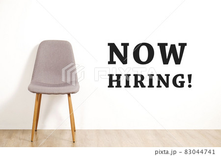 Head hunting help wanted poster concept. Minimalistic composition with chair and blank copy space wall. 83044741