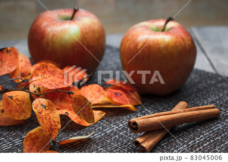 Ripe autumn apples on a background of orange leaves 83045006