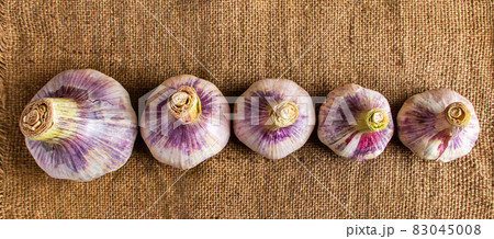 Fresh aromatic garlic on a wooden background. Fragrant spice for cooking. 83045008