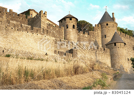 The Ancient Fortress of Carcassonne in the light of the setting sun. French Castle 83045124