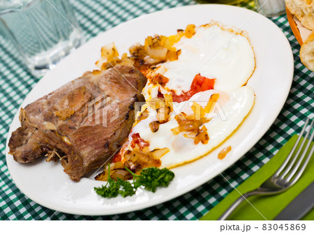 Image of dish of tasty cooked fried pork with fried eggs Image of dish of tasty cooked fried pork with fried eggs 83045869