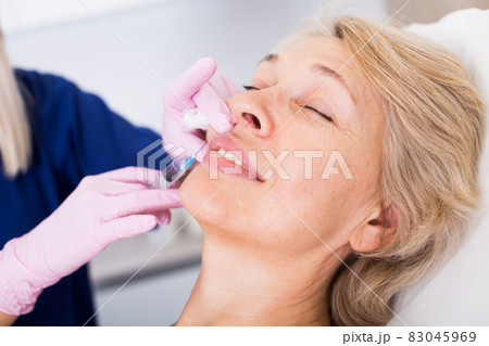Woman during beauty facial injections 83045969