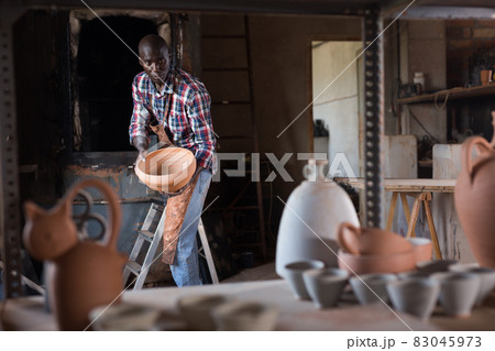Artisan working in pottery workshop Artisan working in pottery workshop 83045973