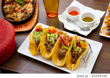 Mexican food tasty tacos with beef, guacamole sauce Mexican food tasty tacos with beef, guacamole sauce 83046100