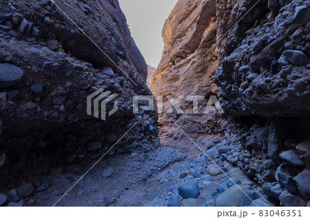 Hiking in a slot canyon of Lake Mead Hiking in a slot canyon of Lake Mead 83046351