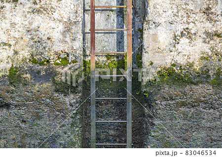 Rusty iron staircase and dirty concrete wall Rusty iron staircase and dirty concrete wall 83046534