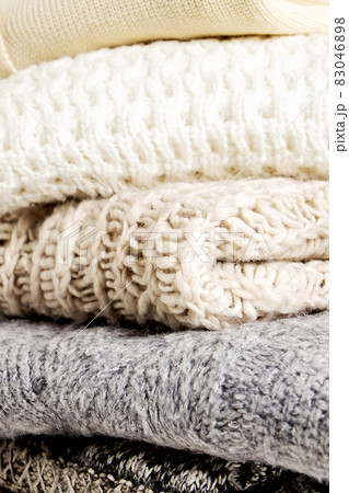 Minimalistic rustic composition with stacked vintage knitted easy chic oversized style sweaters, knitwear outfit. Minimalistic rustic composition with stacked vintage knitted easy chic oversized style sweaters, knitwear outfit. 83046898