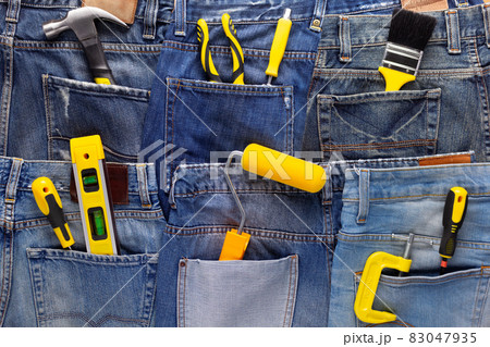 Kit of construction tool in jeans pocket background texture. House renovation concept 83047935