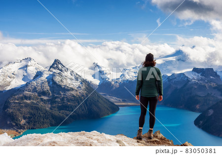 Adventurous Caucasian Woman hiking on top of a Canadian mountain. 83050381