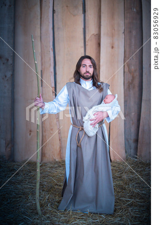 Joseph holding Jesus baby in a lgtb nativity scene Joseph holding Jesus baby in a lgtb nativity scene 83056929