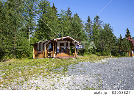 Ruskeala, Russia - July 10, 2021: Wooden house with the signboard "Russian Post" in Russian on the facade Ruskeala, Russia - July 10, 2021: Wooden house with the signboard "Russian Post" in Russian on the facade 83058827