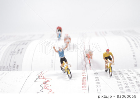 the Mini people, Small figures cycling on open book 83060059