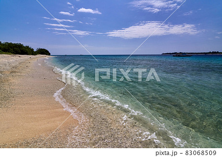 Tropical Asian beach with white sand, turquoise ocean against blue sky with clouds 83068509