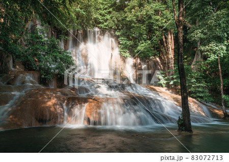 Sai Yok Noi waterfall flowing on limestone in tropical rainforest at national park 83072713