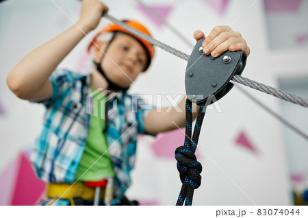 Little boy on zip line, young climber in helmet 83074044