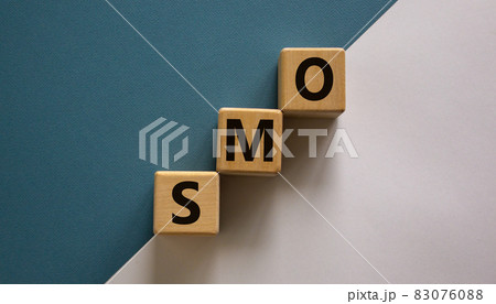 SMO symbol. Wooden cubes with word 'SMO - social media optimization' stacking as step stair on paper blue and white background, copy space. Business and SMO concept. SMO symbol. Wooden cubes with word 'SMO - social media optimization' stacking as step stair on paper blue and white background, copy space. Business and SMO concept. 83076088