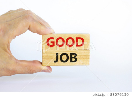 Good job symbol. Concept words 'good job' on wooden blocks on a beautiful white background. Businessman hand. Business and good job concept, copy space. Good job symbol. Concept words 'good job' on wooden blocks on a beautiful white background. Businessman hand. Business and good job concept, copy space. 83076130