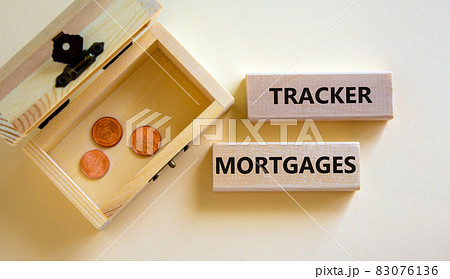 Tracker mortgage symbol. Concept words 'Tracker mortgage' on wooden blocks on a beautiful white background. Small chest with coins. Business, tracker mortgage concept. Tracker mortgage symbol. Concept words 'Tracker mortgage' on wooden blocks on a beautiful white background. Small chest with coins. Business, tracker mortgage concept. 83076136